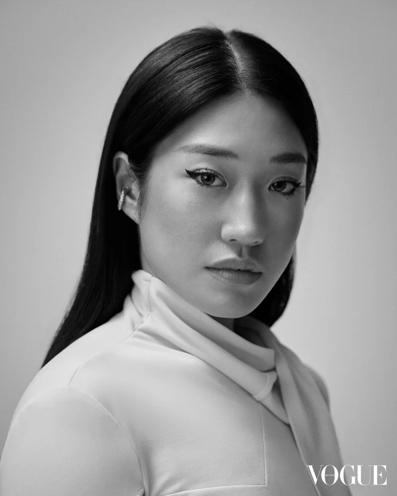 흰 터틀넥을 입고 카메라를 바라보는 페기 구의 흑백 포트레이트